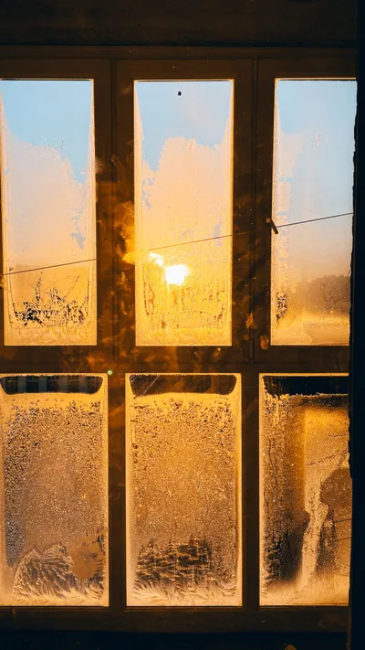 Frost forming on a window during cold weather