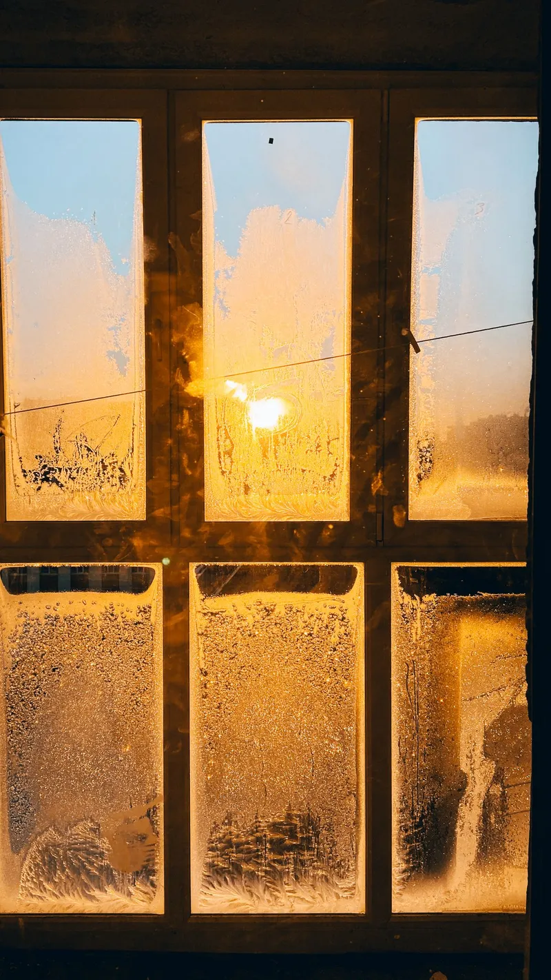 Frost forming on a window during cold weather