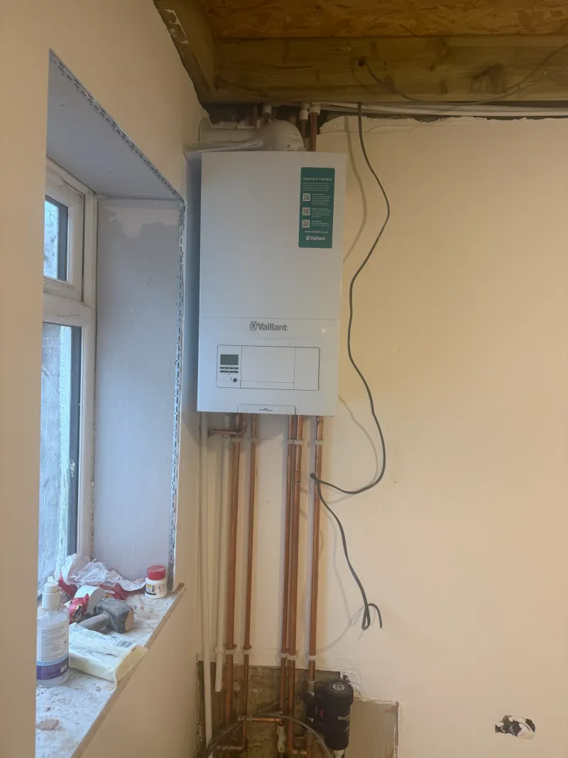 Completed Vaillant boiler installation with flue and magnetic filter as part of a St Albans renovation — Pristine Gas Ltd