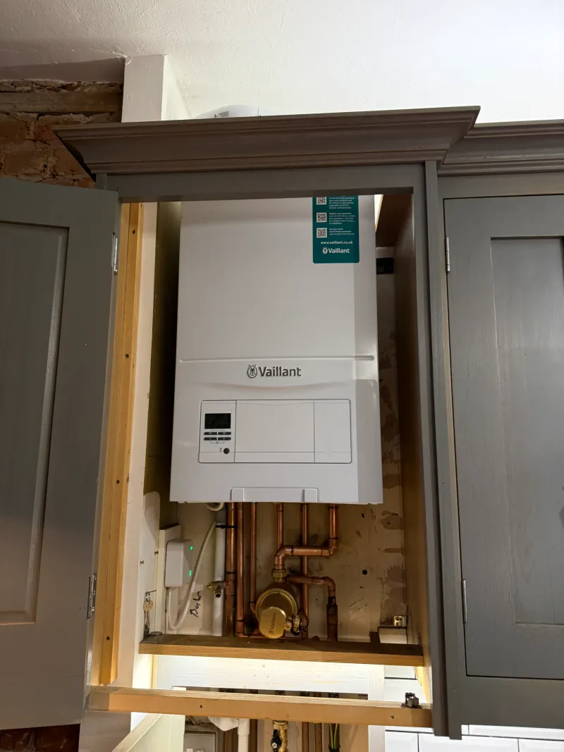 Vaillant ecoFIT pure boiler concealed inside a grey kitchen cabinet in Chiswick W4 — Pristine Gas Ltd