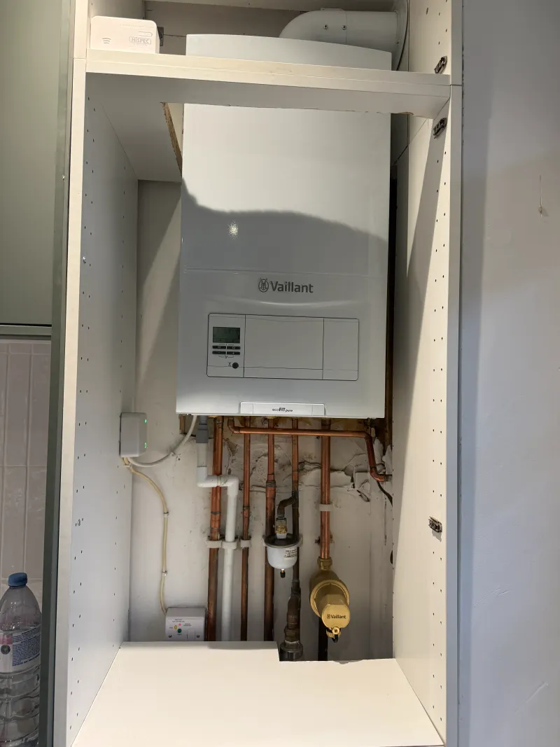Vaillant boiler concealed in a kitchen cabinet with wireless thermostat in North West London — Pristine Gas Ltd